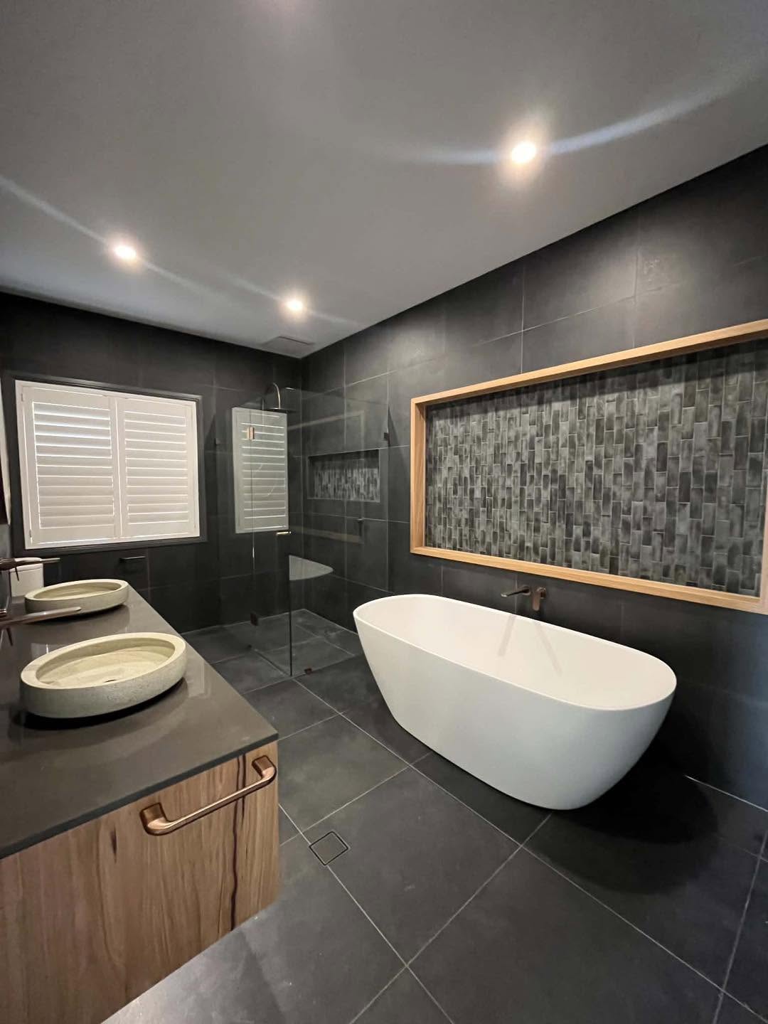 Premium bathroom renovation by Spriggs and Co — dark luxury ensuite with double timber vanity and illuminated mirrors